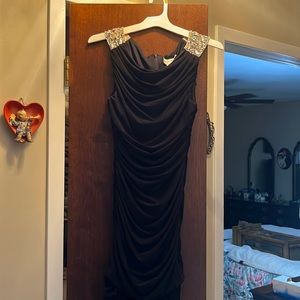 Black cocktail dress with shoulder detail